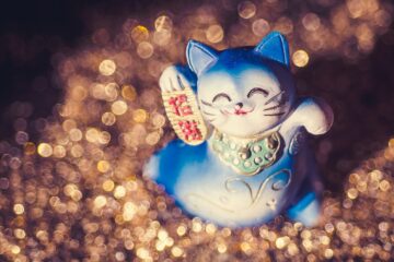 a blue cat figurine sitting on top of a table